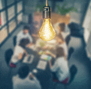 group of people coming up with a new idea and light bulb showing it
