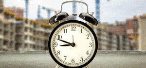 photo of a clock with a building being constructed in the background for project mgmt. case study