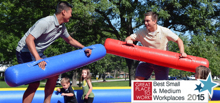 two IPM employees playing a game at IPM annual family picnic for 2015 Best Small & Medium Workplaces news