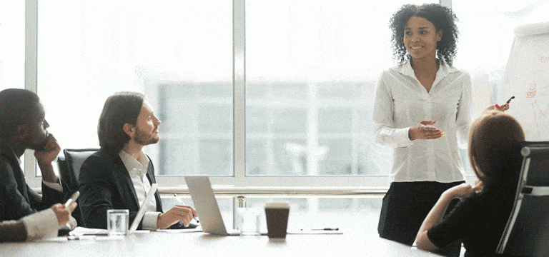 project manager leading a meeting with three coworkers