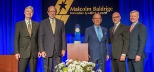 Photo with Rich Panico and Larry Meyer receiving the Malcolm Baldrige award
