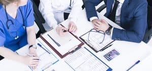 two doctors and a project manager image for the healthcare strategy realization service page