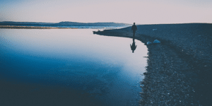 serene reflection walking by the water